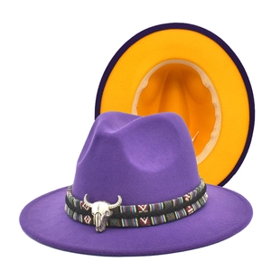 Detail of purple fedora hat featuring yellow brim lining and silver bull head metal buckle