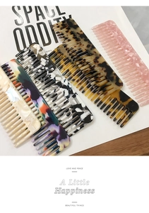 Detail showing various acetate leopard print hair combs with tortoiseshell patterns