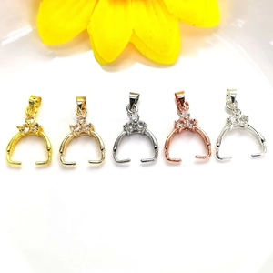 Macro view of 14K gold plated pendant clasps set with sparkling zircons in 5 colors