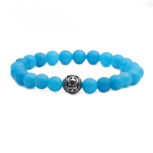 Blue malachite bead bracelet with vintage silver hollow cross charm on white background