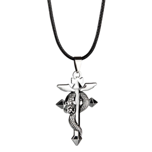 Close-up of vintage stainless steel cross pendant with snake wrap and silver wings detail