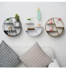 Modern set of three circular metal wall shelves in black, white, and gold finishes