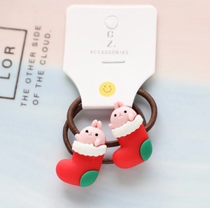 Detail of red Christmas sock and pink bunny hair ties with high-elastic bands for girls