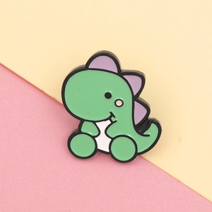 Detailed close-up of a cute green dinosaur enamel pin with purple plates on pink background
