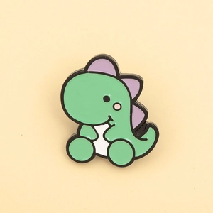 Detailed macro view of a green cartoon dinosaur enamel pin with purple spikes