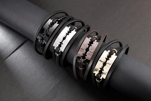 Detail view of multi-layer leather bracelets with razor blade charm in four colors