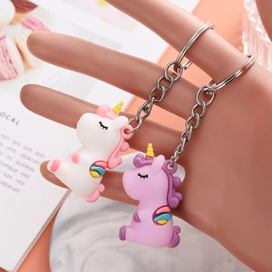 Cartoon unicorn keychain pendants in white and purple PVC, handheld with metal rings