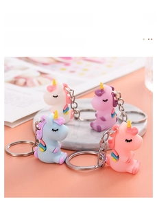 Group of colorful cartoon unicorn keychains in white, purple, blue and pink soft PVC
