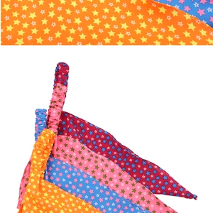 Detailed stack of colorful star print bandanas showing the elastic strap and fabric texture