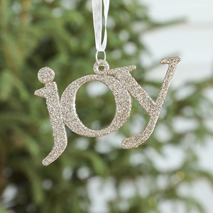 Golden glitter 'joy' letter ornament hanging on a Christmas tree with white satin ribbon
