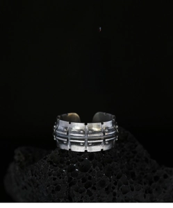Macro detail of industrial style track link ring with vintage silver texture