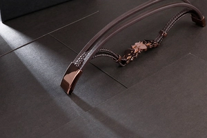 Detail of multi-layer braided leather bracelet with bronze punk skull and magnetic clasp