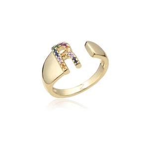 Macro shot of gold-plated open ring with letter R motif made of colorful stones