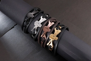 Detail of woven leather bracelets with skull motifs in silver, gold, and rose gold finishes