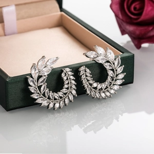 Macro shot of silver laurel wreath earrings with sparkling marquise-cut cubic zirconia stones