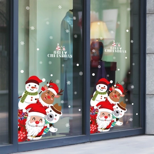 Christmas window stickers featuring Santa, snowman, and reindeer on a glass door