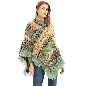 Close-up of bohemian knit shawl featuring zigzag geometric patterns and fringe detail