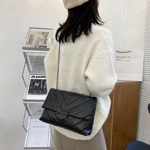 Classic black V-quilted faux leather chain bag shown with an elegant crossbody fit