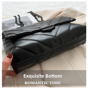 Detail view of the black quilted chain bag with elegant stitching and matte metal clasp