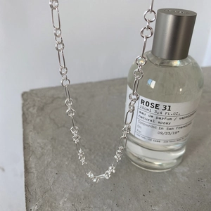 Detail of minimalist 925 sterling silver chain necklace with alternating silver loops