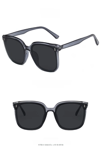 Detail view of transparent grey square frame sunglasses with dark grey resin lenses