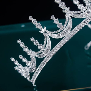 Close-up of elegant silver bridal crown with sparkling crystal rhinestones on dark background