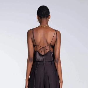 Satin backless halter top in black featuring spaghetti straps and a crisscross tie design