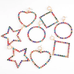 Detail view of gold-plated alloy earrings with colorful rhinestones and faux pearls