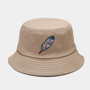 Detail of colorful feather embroidery on beige cotton bucket hat with reinforced brim