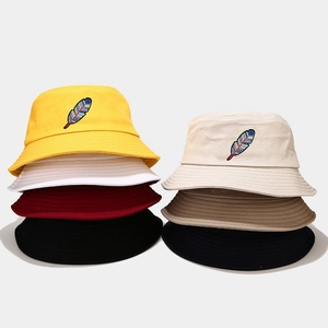 Detail of embroidered feather pattern bucket hats available in seven different colors