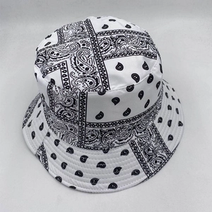 Detailed top view of a white reversible bucket hat featuring classic black bandana patterns