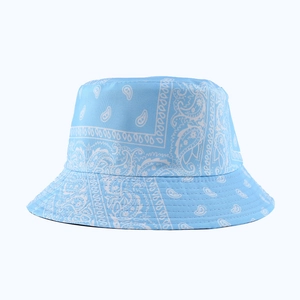 Detailed view of light blue bucket hat with white paisley pattern and precise stitching