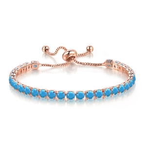 Detail of rose gold tennis bracelet with round blue stones and adjustable pull slider