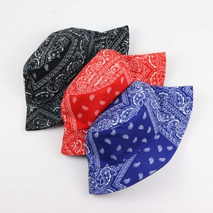Overhead view showing black, red, and blue bandana paisley print reversible bucket hats