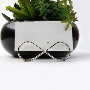 Silver infinity shape wedding place card holder with elegant table seating card