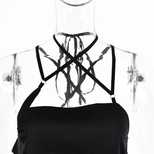 Detail of black satin camisole featuring cross halter neck and glossy fabric texture
