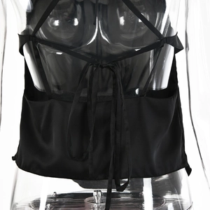 Detail shot of the back lace-up design on a black satin camisole with crossed ties