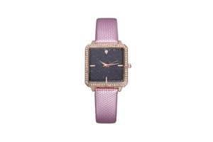 Macro view of square rose gold watch with starry blue dial and rhinestone bezel