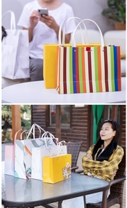 Outdoor lifestyle shot of various stylish paper gift bags with handles on glass table