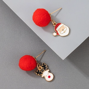 Detail of Christmas earrings featuring red pom-poms with Santa and Reindeer charms