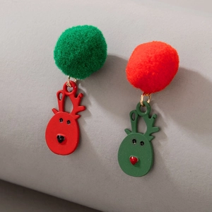 Detail of Christmas earrings featuring reindeer charms and colorful plush balls