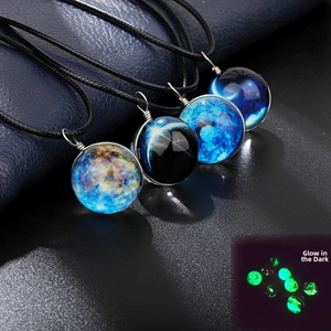Detailed macro view of luminous nebula glass ball pendants on black woven ropes