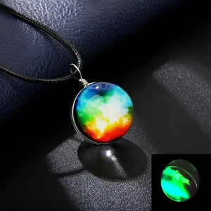 Detailed view of handmade galaxy glass pendant showing glowing effect in the dark