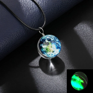 Detail shot of a double-sided glass earth globe pendant with a luminous green glow effect