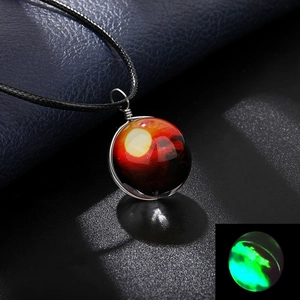 Detail of handmade galaxy glass pendant showing glowing effect in the dark