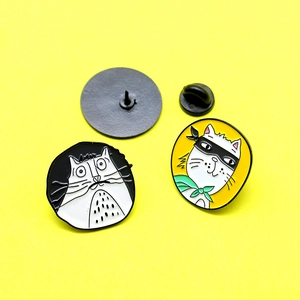 Cartoon enamel cat pins featuring white kitten and masked aviator cat designs