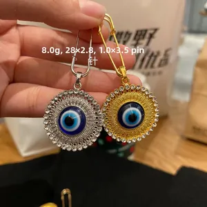 Detail view of Evil Eye lapel pins with rhinestones in gold and silver finish
