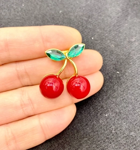 Cute cherry brooch with red enamel spheres and green crystal leaves in gold finish