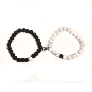 Matching magnetic bracelets with matte black and marble white stone beads for couples