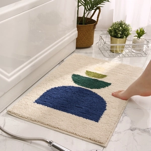 Absorbent plush bathroom mat with colorful geometric semi-circle patterns on beige base